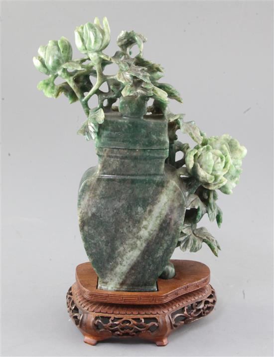 A Chinese green mottled jadeite vase and cover, 20th century, height 22cm, wood stand